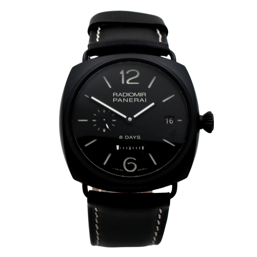 Front view of the Panerai Radiomir 8 Days watch with a matte black ceramic case, black dial, and black leather strap, displayed on a clear stand.